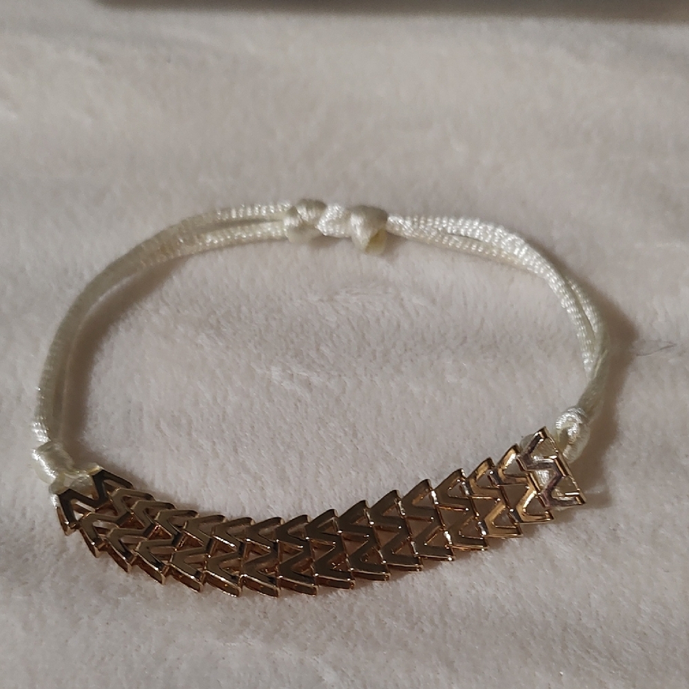 Elegant Gold Bracelet with White Cord